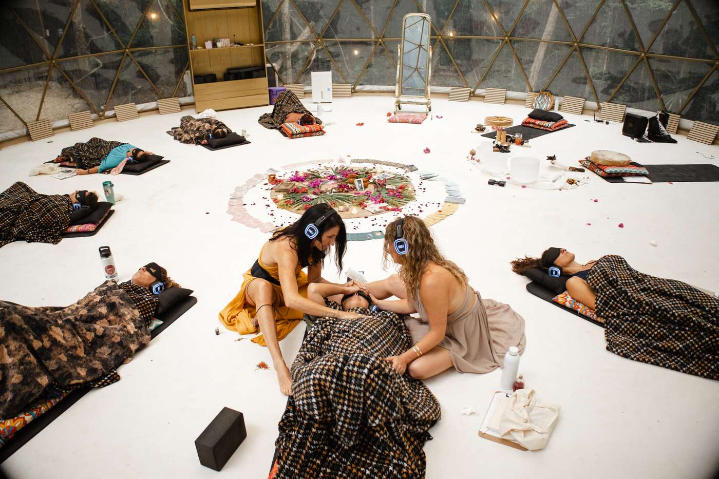 Anya and Bre kneeling at the centre of the dome, tending a resting sister