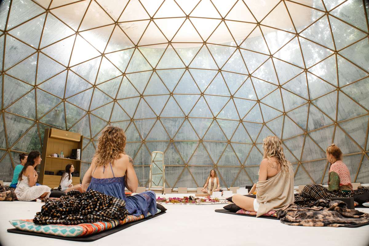 Sisters seated in circle beneath the vast gold dome, light pouring through the crown