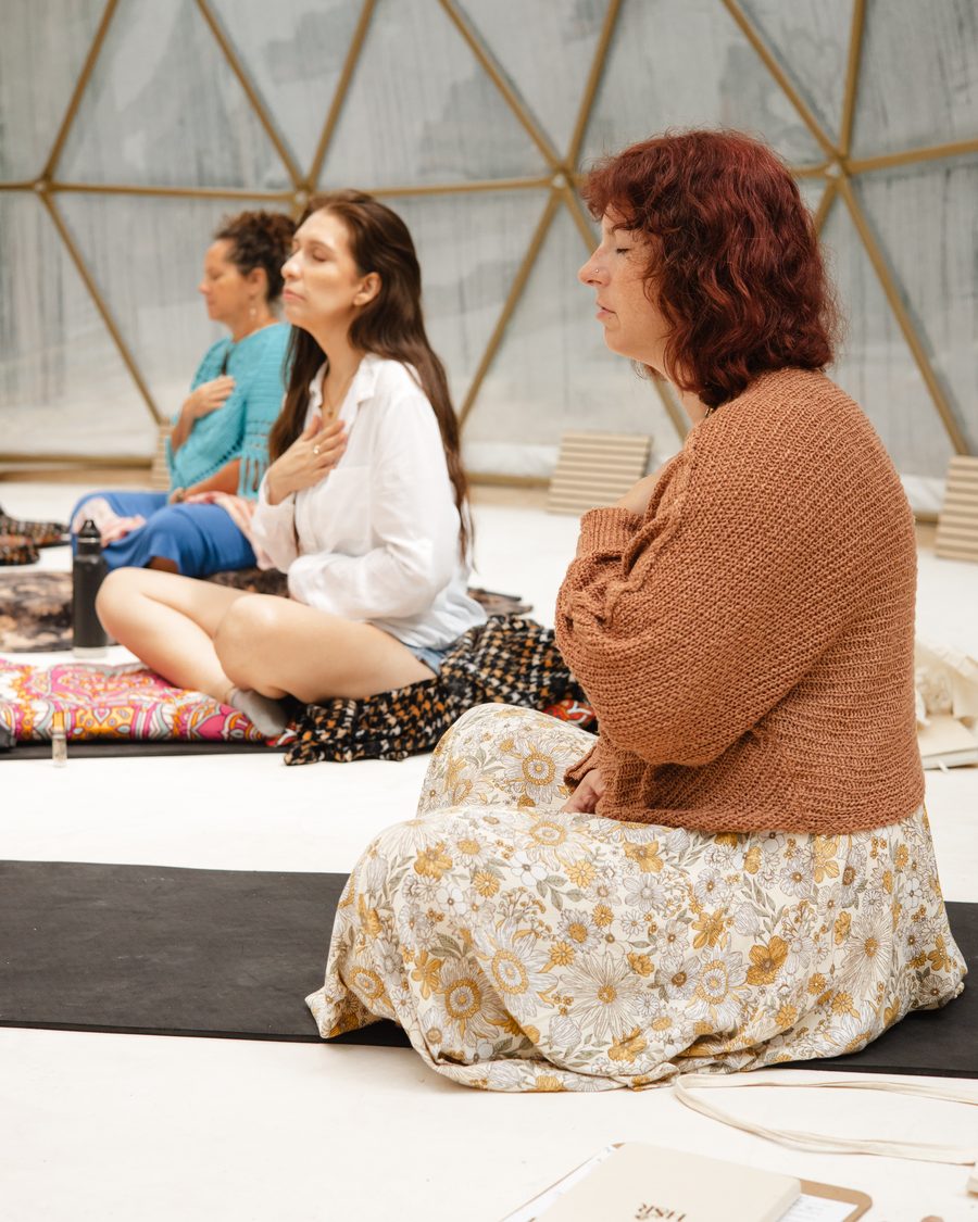 Sisters seated in the dome, hands on their hearts, eyes closed as the circle opens
