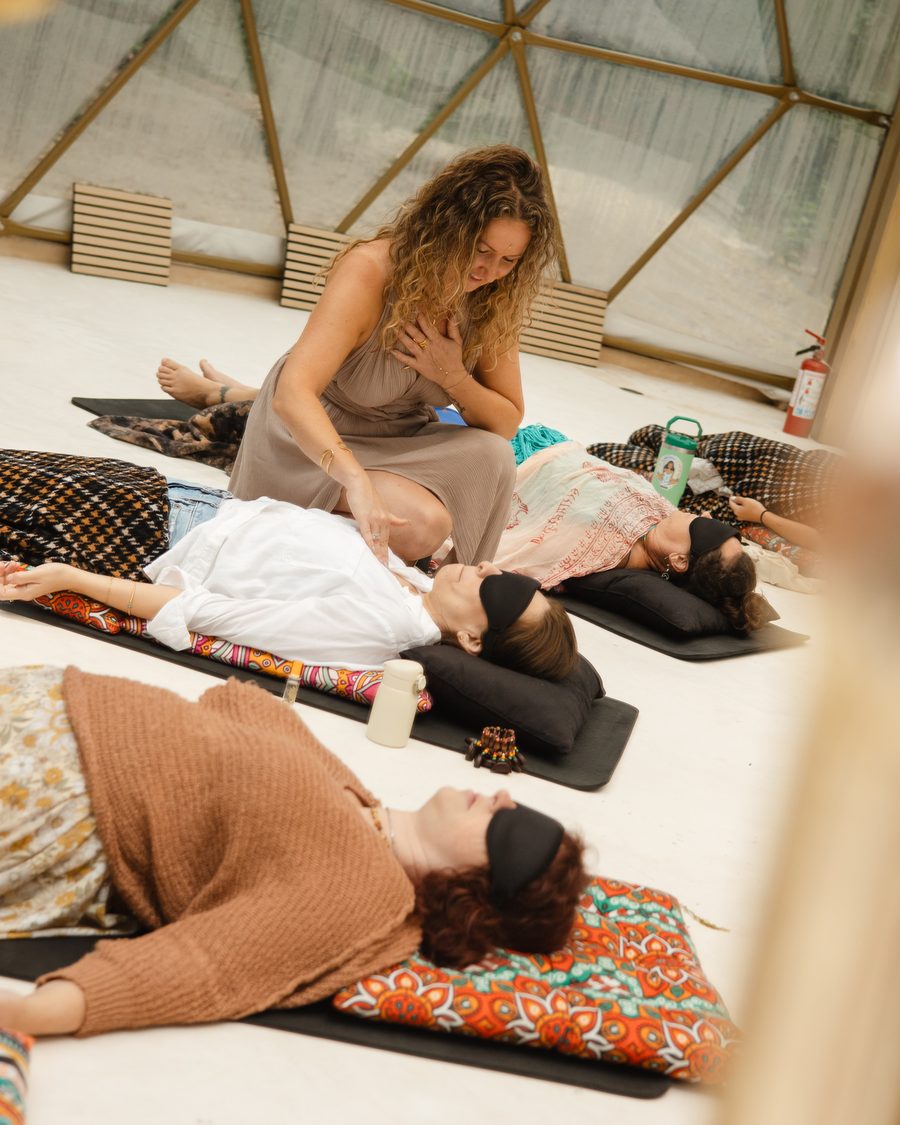 Anya with one hand on her own heart, tending a resting sister as the circle settles