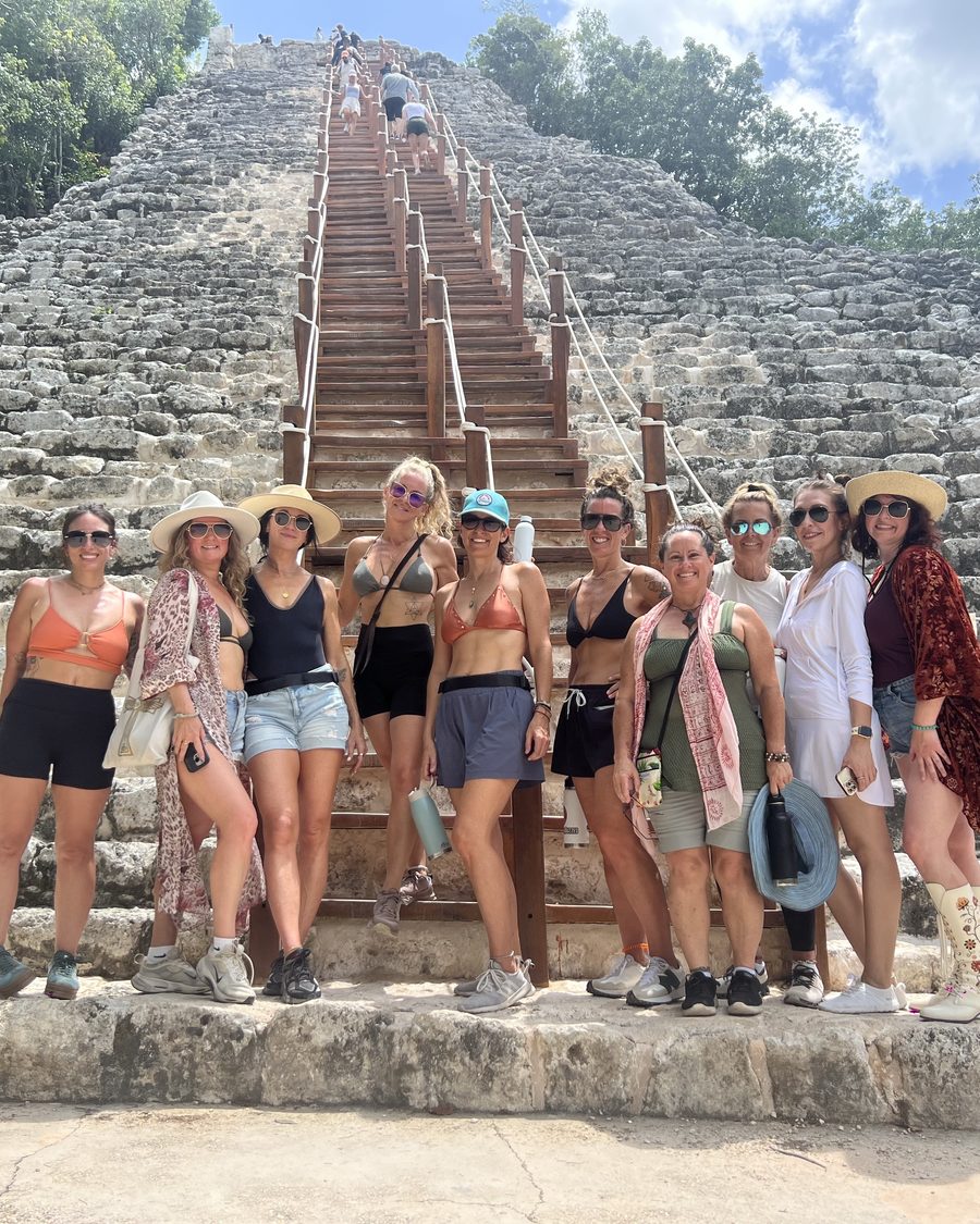 The circle of sisters gathered at the foot of the great stone stairway at Coba