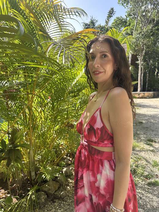 Catherine in a rose dress with a golden moon painted on her brow