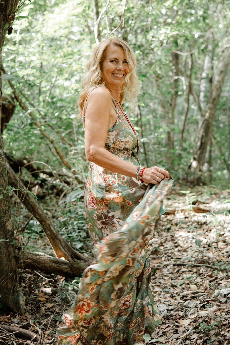 Kristi in the Tulum jungle, turning in a floral dress